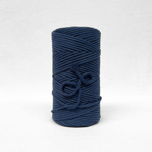 5mm navy blue string standing alone on white wall showing up close colour and texture