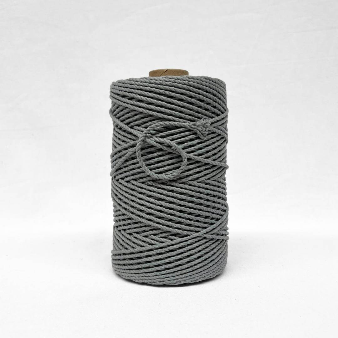 one roll os strong grey cotton recycled macrame rope standing upright with white background
