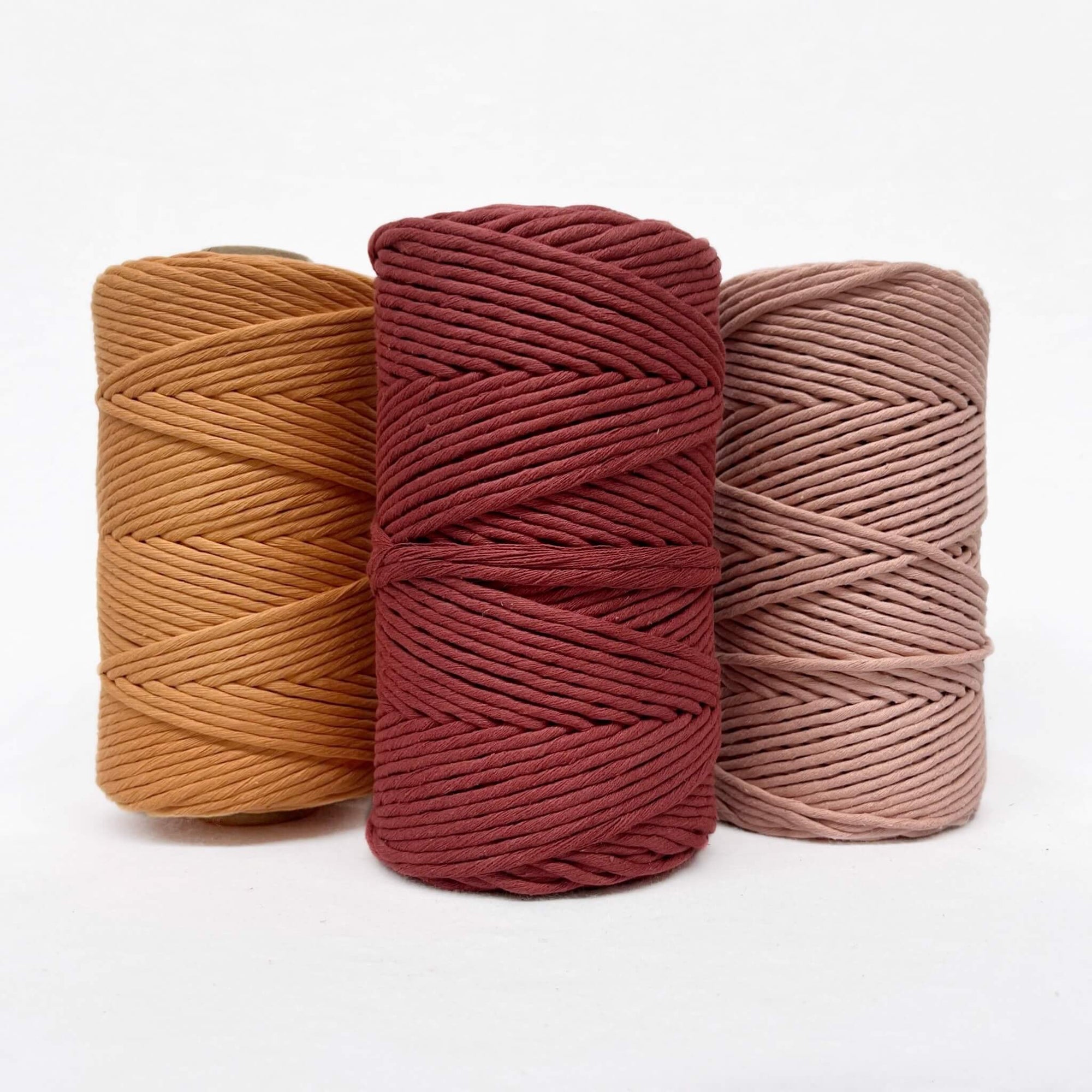 caramel red soft peach pink macrame cotton cord in group photo for workshops on white wall