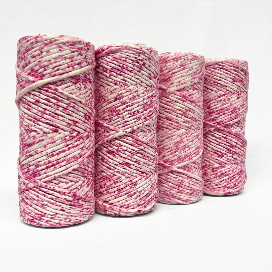 hot pink water colour cotton cord four rolls standing next to each other showing variation between each rolls on white background 