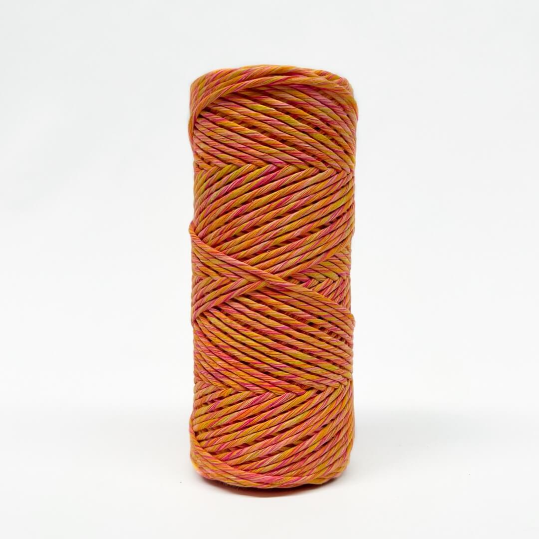 single roll of orange, pink and yellow mixed macrame string in 4mm on white background