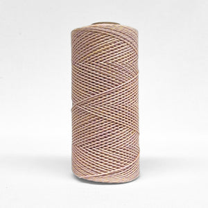 single roll if 1.5mm lilac lover cotton string stadning upright on wite background