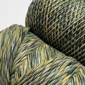 two rolls of green and yellow mixed macrame string in close up showing colour and texture