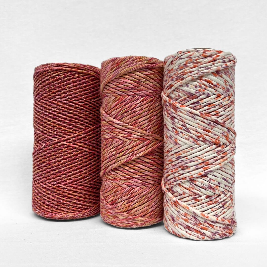 three rolls show casing flora fiesta colour way in three different options 4mm mixed string 1.5mm mixed string and confetti string with white back ground 