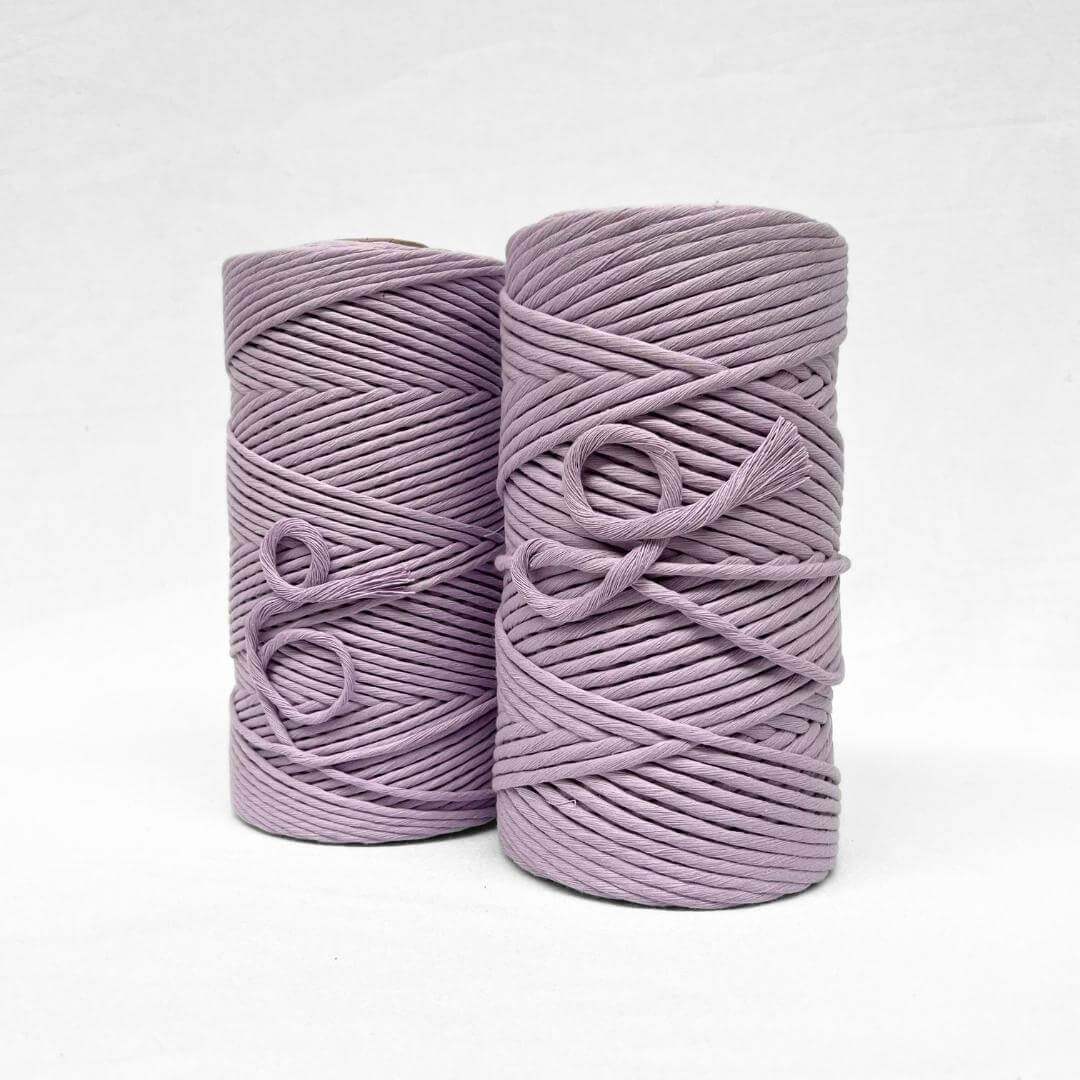 two medium pruple rolls of 3mm and 5mm cotton on white background