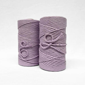 two medium pruple rolls of 3mm and 5mm cotton on white background