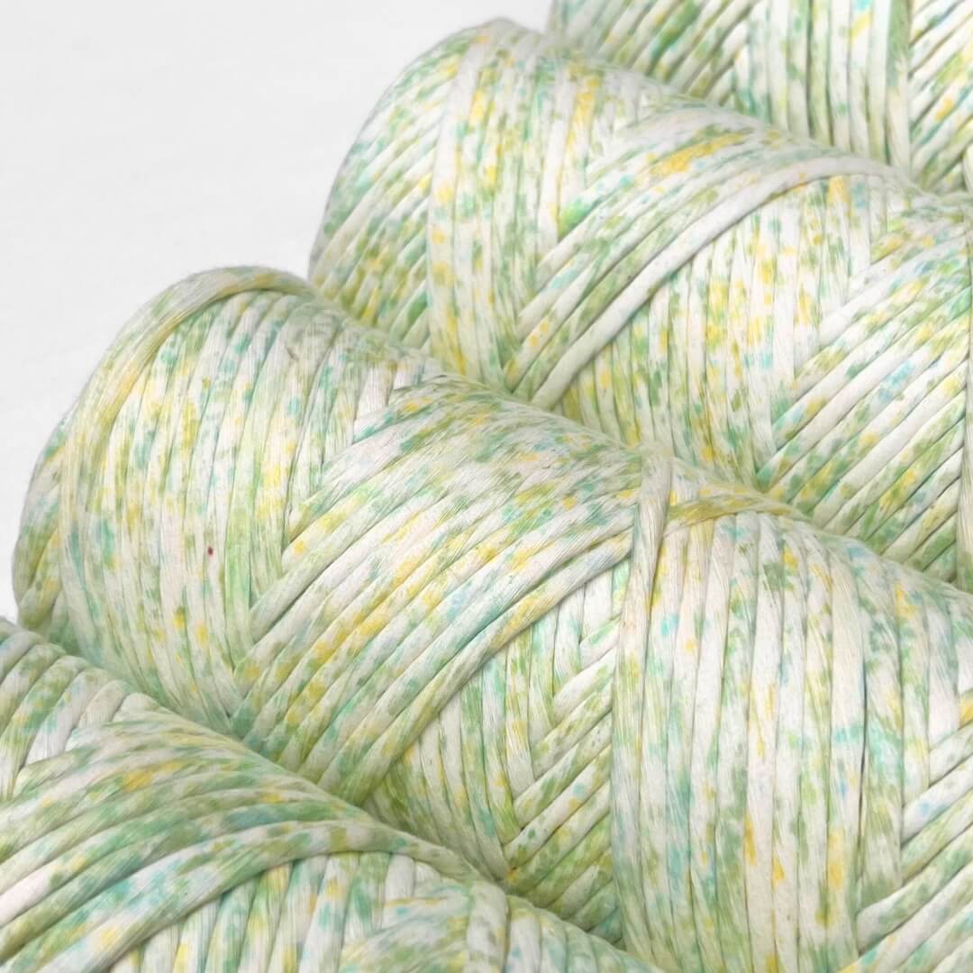 four rolls of lime splice watercolour macrame string standing upright on white background 