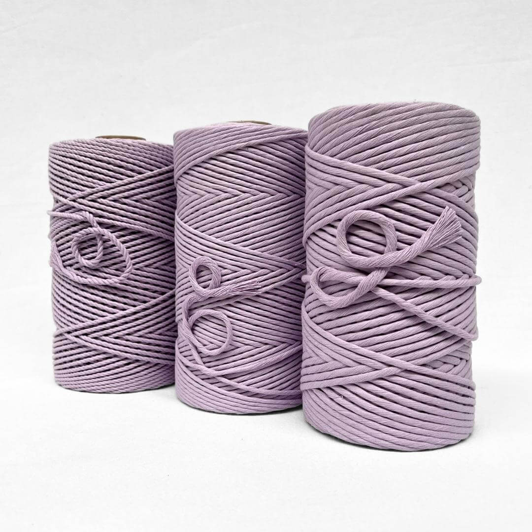 three rolls of cotton in 4mm rope 3mm and 5mm string in orchid purple on white back ground