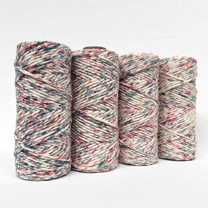 four rolls of harlequin light confetti cotton cloud 9 cord standing upright on white background 