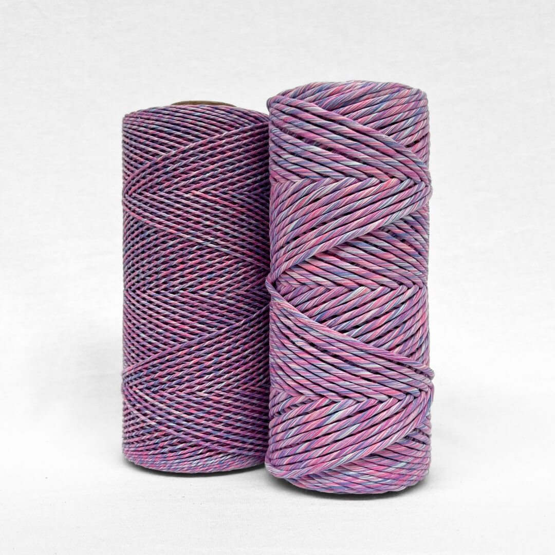 two cones of mixed macrame string in lavender skies colour shpwing a 1.5mm and 4mm variant on white back ground'