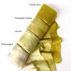 bright yellow muted yellow pineapple lemon champagne silk ribbon rolls for weaving on white background