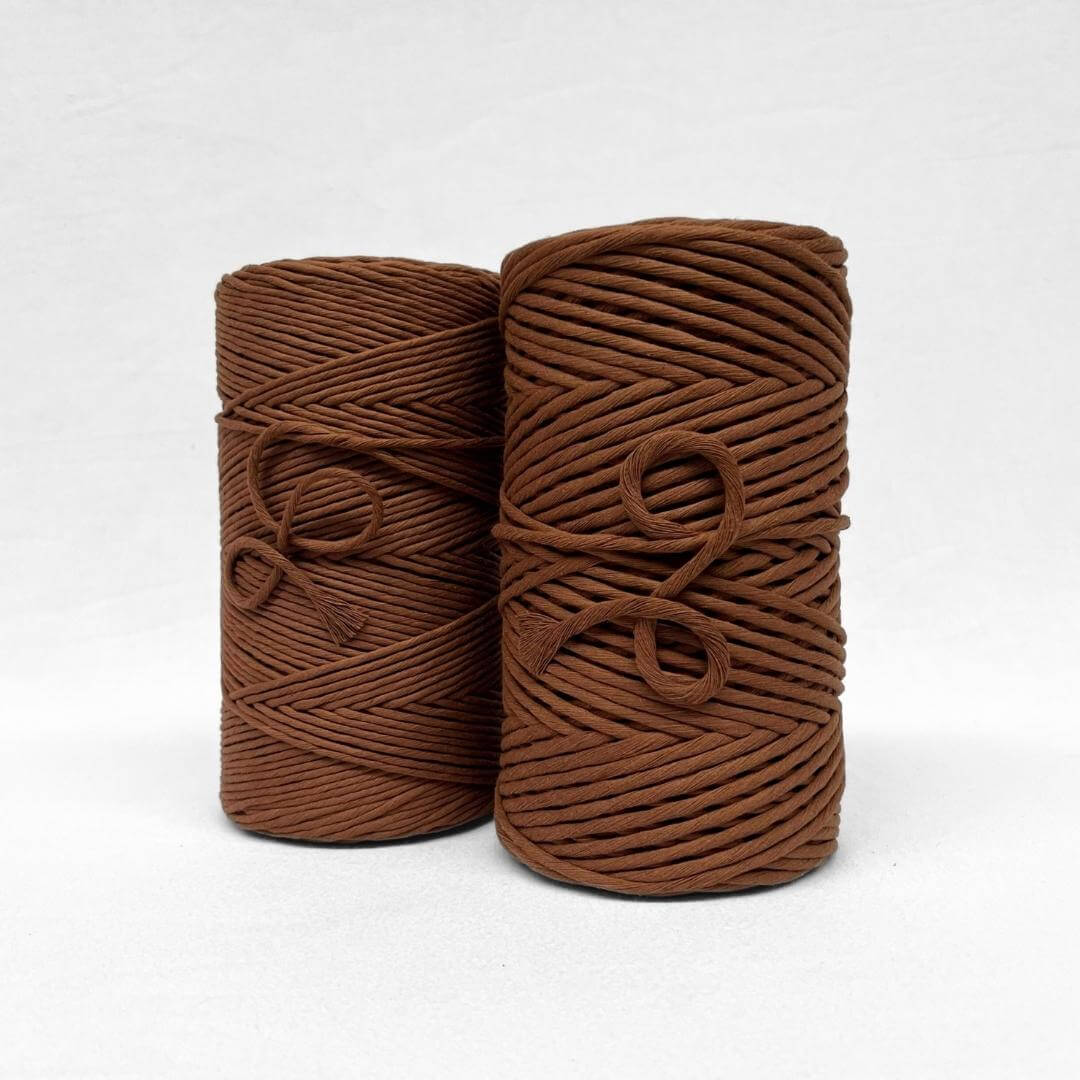 two cotton rolls 3mma nd 5mm chocolate brown showing size difference on white background
