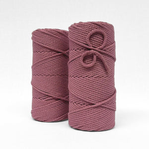 two rolls of primrose pink braided cotton 4mm cord standing side by side on white back ground