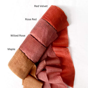 red rose deep rose maple orange silk ribbon roll four colours on white background