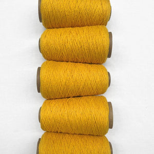 Bright sunflower yellow wool cord five rolls laying side by side from top tp bottom of photo on white background