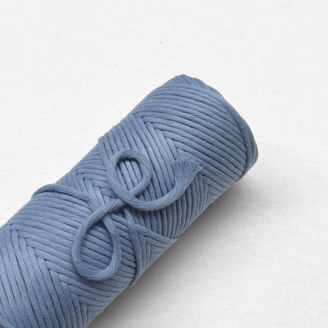 roll of lavender blue premium cotton cord laying on white back ground with small brushed section to show softness