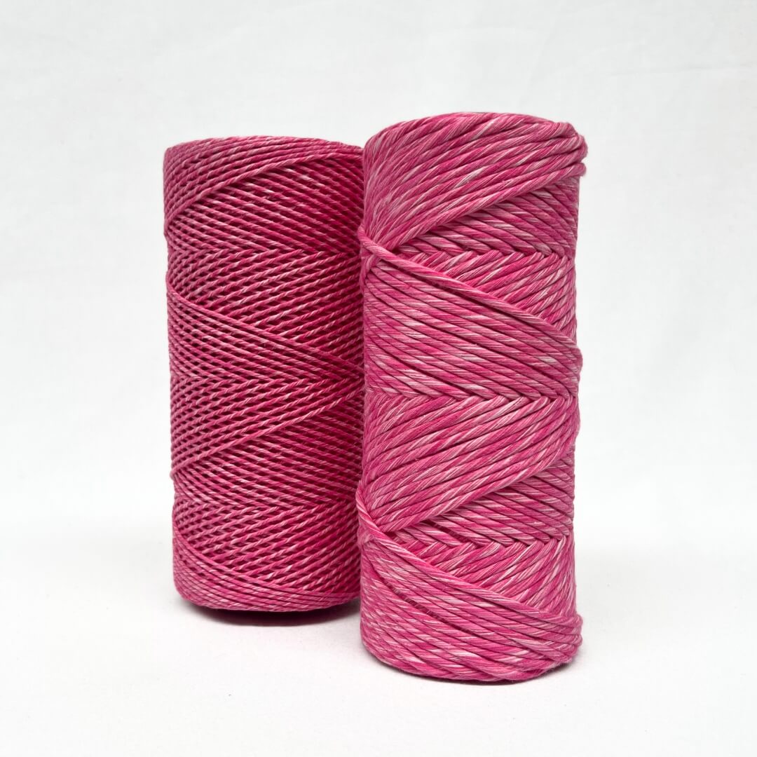 Hot pink pretty pink mixed macrame cord two rolls 1.5mm and 4mm standing side by side with white background
