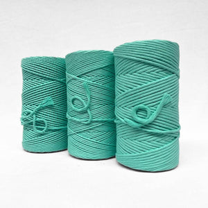 three rolls of ice green in 3mm string 5mm string and 4mm 3ply rope standing side by side on white background 