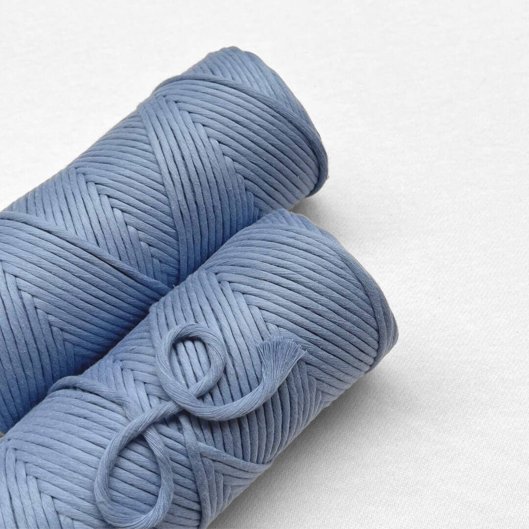 two rolls of lavender blue cloud 9 string on white background