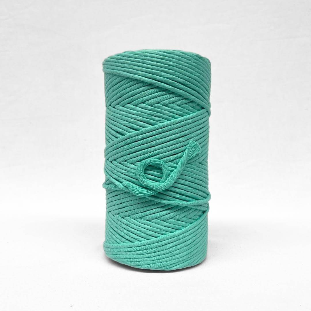 bright green macrame cotton string for weaving on white wall