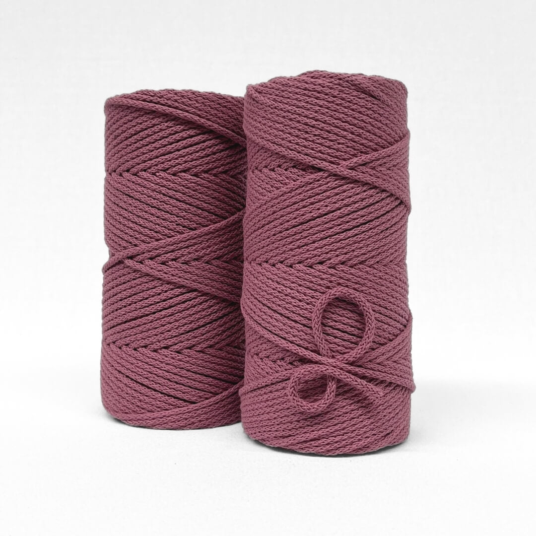 two rolls of Plum pink braided cotton 4mm cord standing side by side on white back ground