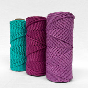 combination photo of three vibrant colours of cotton cord in turquoise rich orchid and royal purple standing against white background