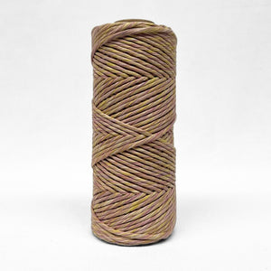 single roll of 4mm mixed recycled string in purple and gold yellow colour way on white wall