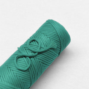 one roll of seagreen cloud 9 string laying flat on white background to emphasise vibrant colour'