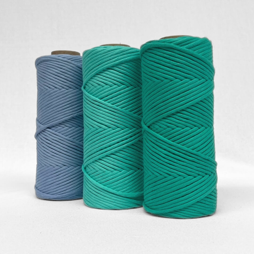 three rolls of string in lavender blue, deep mint, seagreen on white background