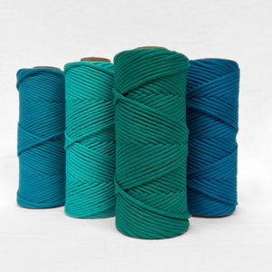 four macrame cord rolls in combination photo showing matching colours barrier reef turquoise jewel green and mykonos blue all standing side by side on white background