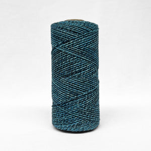 1.5mm blue and black two toned recycled macrame cord close up image showcasing the unique detail of the rolls on white background 