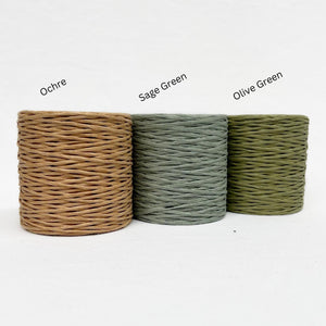 muted colours group image of paper twine on white back drop