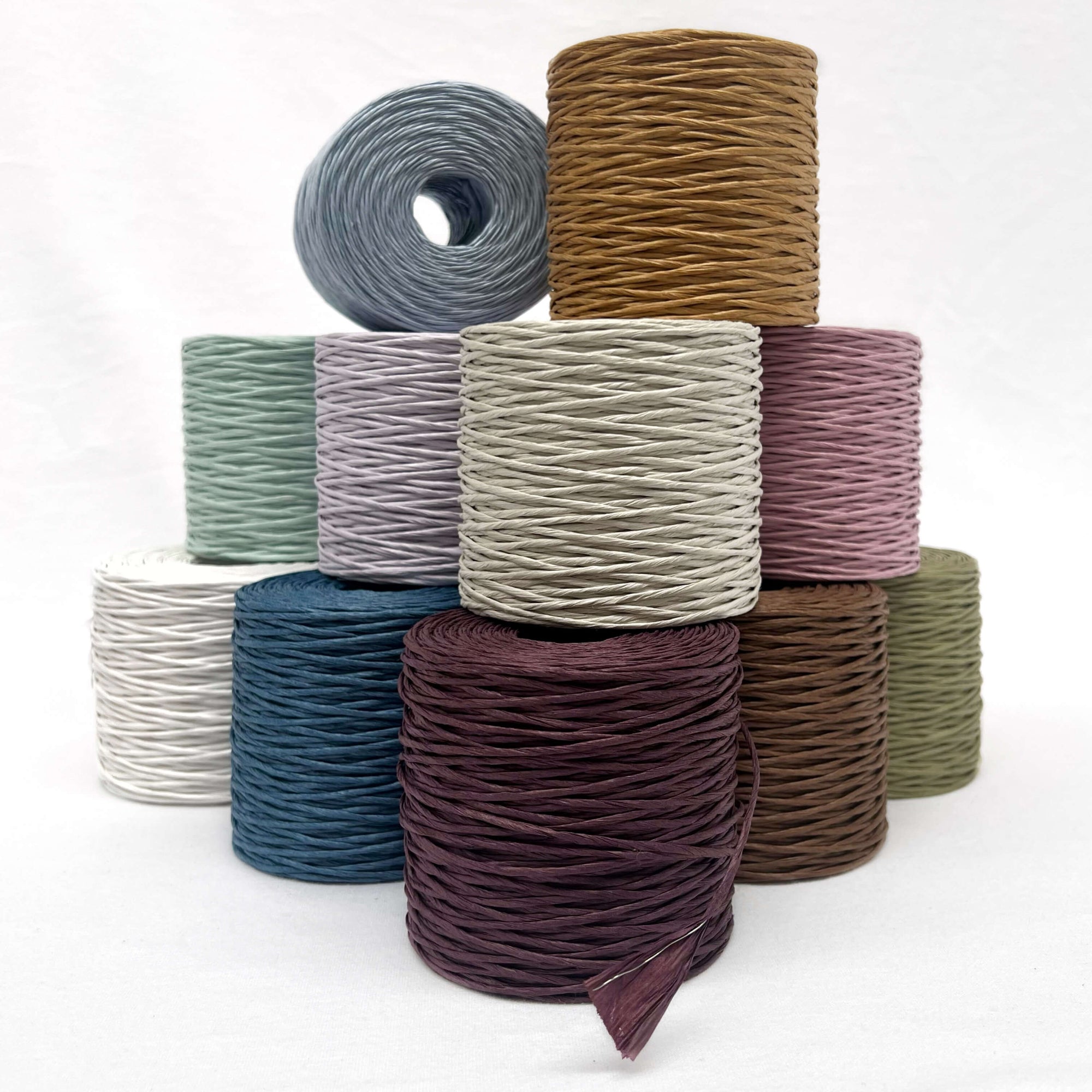 group photo of eleven colours of paper string with internal wire white background