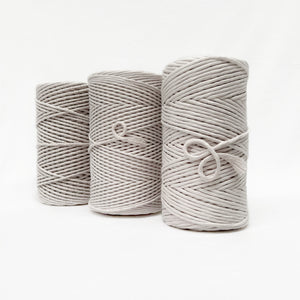 three sizes of ivory macrame cord standing in a line