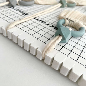 side view of macrame pin board showing string looping through end opening for structure