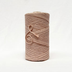 soft pink neutral photo of macrame string on white background